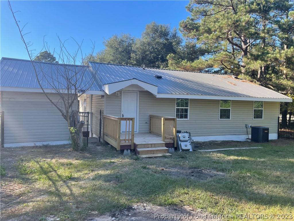 286 Doc Brown Road Raeford, NC 28376 - Photo 5 of 12 a view of a house with a yard and wooden fence