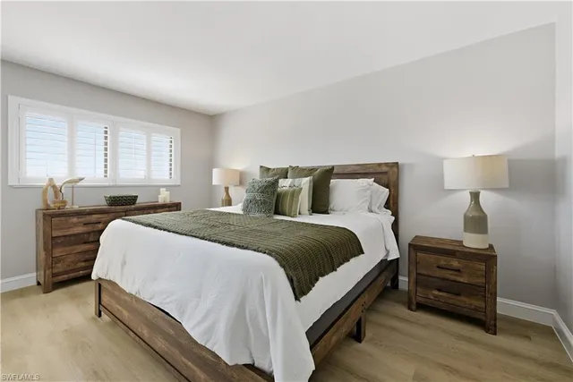 a bedroom with a bed and a night stand