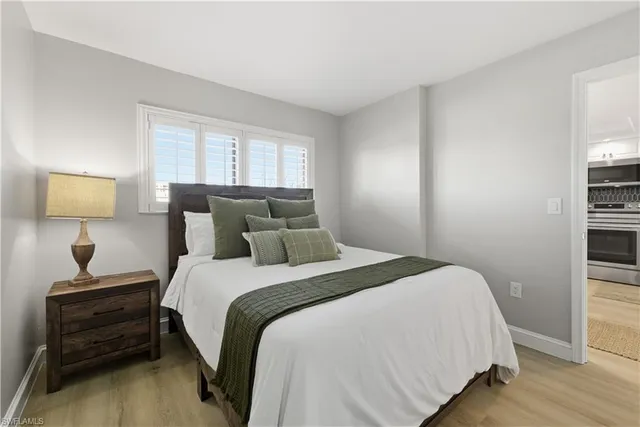 a bedroom with a bed and a lamp on table