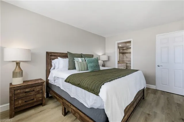 a bedroom with a bed and a night stand