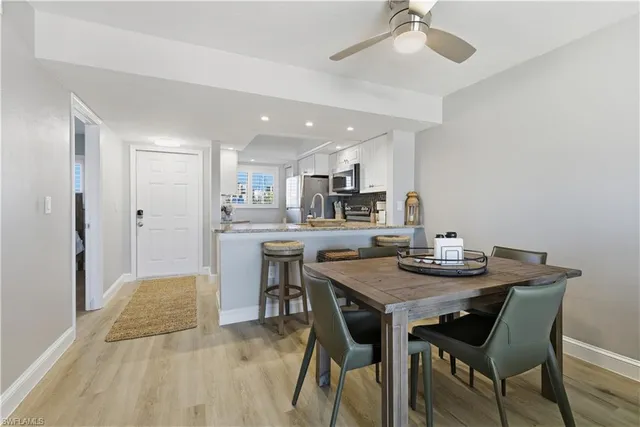 a view of kitchen with cabinets table and chairs
