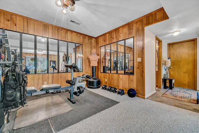 a very nice looking room with large windows and furniture