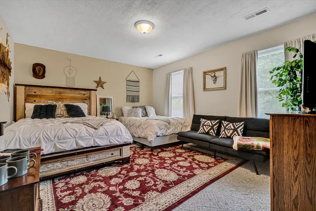 a bedroom with a bed and a couch