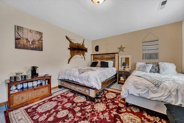 a bedroom with bed and a book shelf