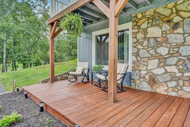 a view of a patio with a table and chairs next to a yard