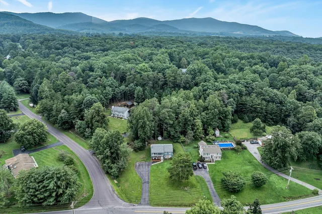 a view of a lush green hillside and a houses