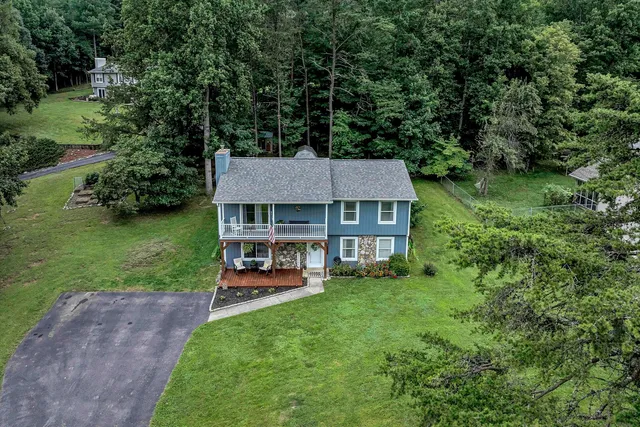 an aerial view of a house with a yard table and chairs