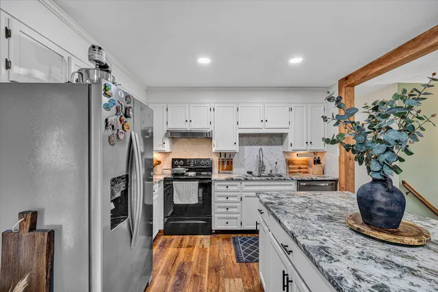 a kitchen with refrigerator and window