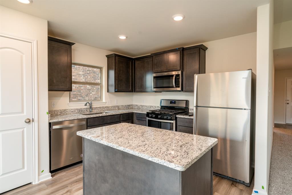 232 Micah Lane Ferris, TX 75125 - Photo 17 of 32 a kitchen with stainless steel appliances granite countertop a refrigerator stove microwave and sink