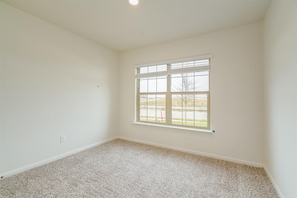 232 Micah Lane Ferris, TX 75125 - Photo 21 of 32 Carpeted spare room with baseboards
