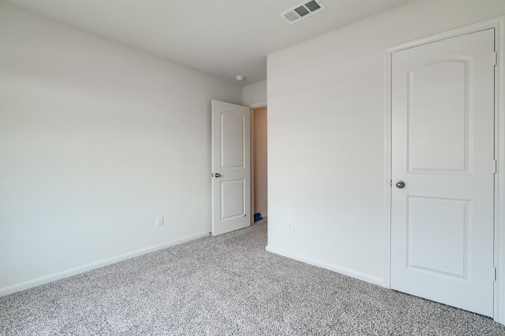 232 Micah Lane Ferris, TX 75125 - Photo 22 of 32 Unfurnished bedroom featuring carpet and baseboards