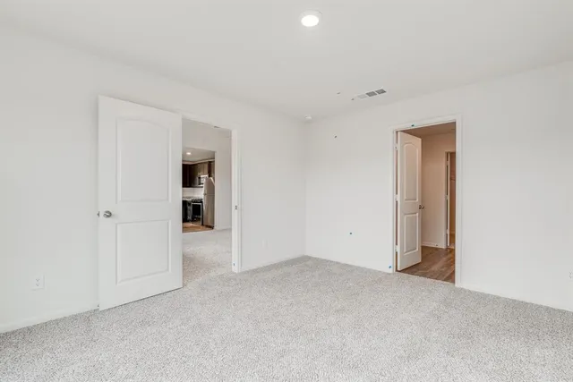 a white bath tub sitting next to a white sink and vanity