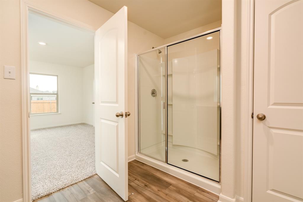 232 Micah Lane Ferris, TX 75125 - Photo 26 of 32 a bathroom with a glass shower door
