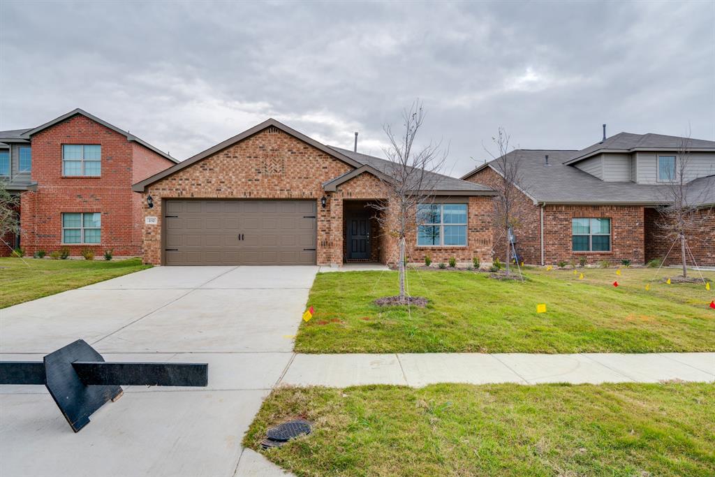 232 Micah Lane Ferris, TX 75125 - Photo 8 of 32 a front view of a house with a yard and garage