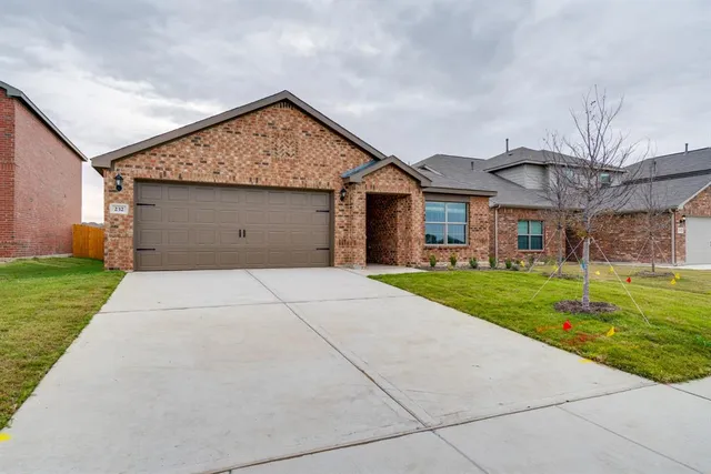 an empty room with windows and chandelier fan