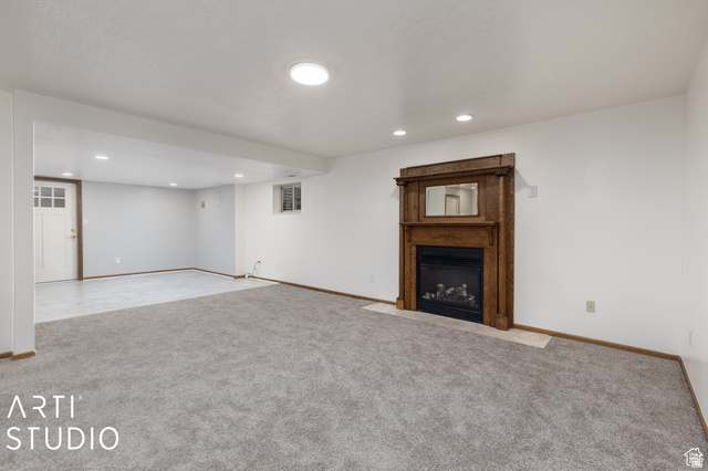 2807 North Ogden Canyon Road Eden, UT 84310 - Photo 34 of 72 Spacious room with a wood-mantled fireplace featuring a black insert and a light-toned hearth