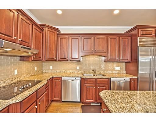 82 Edwardel Road Needham, MA 02492 - Photo 4 of 25 a kitchen with stainless steel appliances granite countertop a sink stove and cabinets