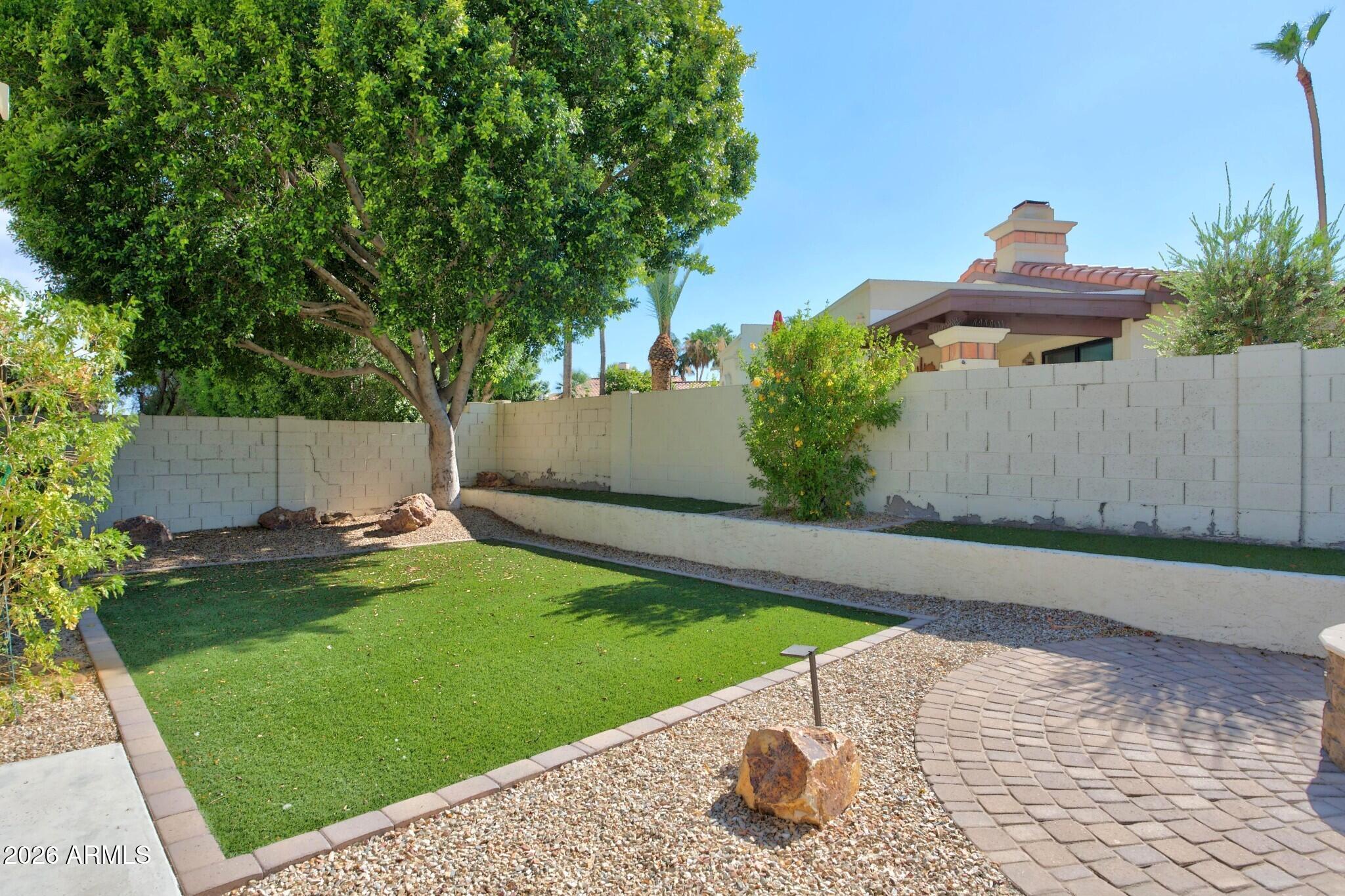 4615 East Monte Way Phoenix, AZ 85044 - Photo 11 of 35 a garden with trees in the background