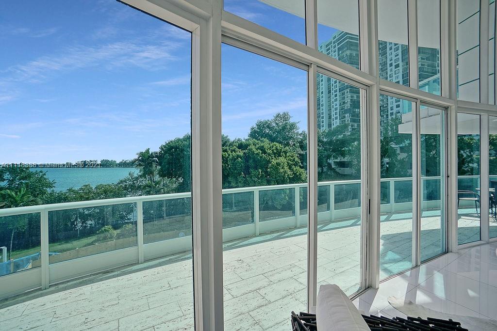 2127 Brickell Avenue, Unit 503 Miami, FL 33129 - Photo 11 of 54 a view of a deck with a floor to ceiling window and wooden fence