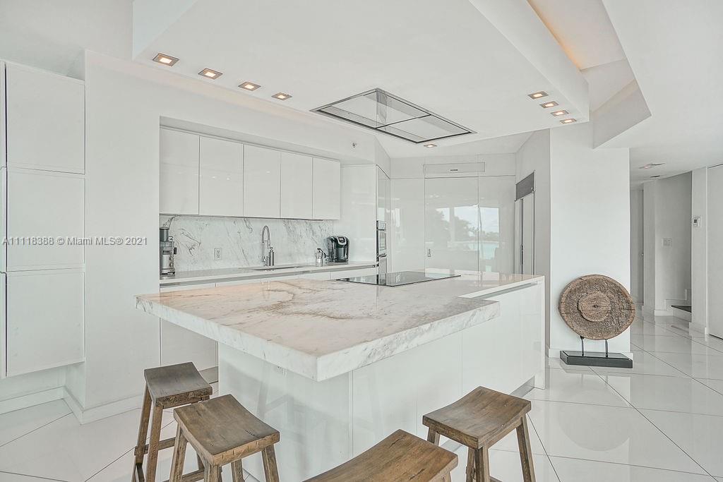 2127 Brickell Avenue, Unit 503 Miami, FL 33129 - Photo 13 of 54 a room with a table chairs and a painting on the wall