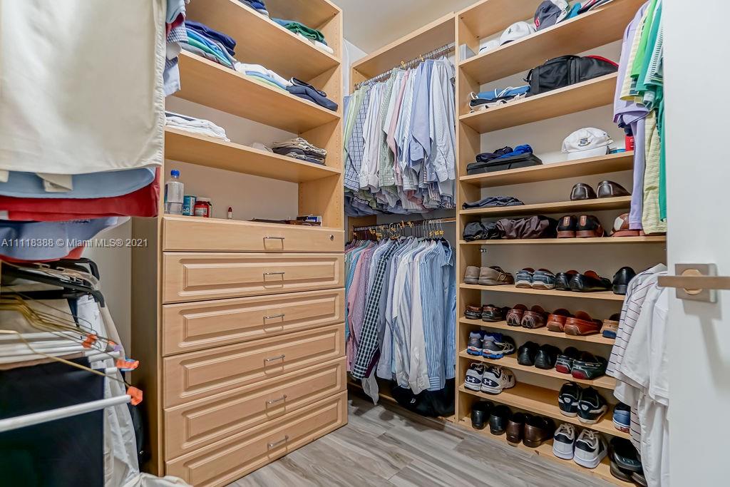2127 Brickell Avenue, Unit 503 Miami, FL 33129 - Photo 27 of 54 a view of walk in closet with clothes and shoes