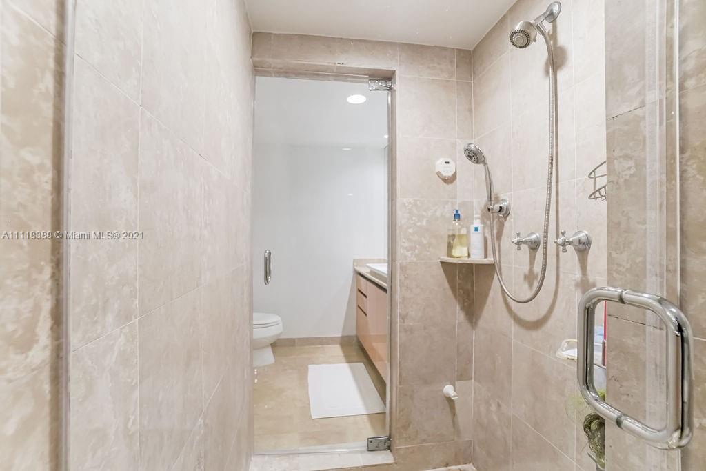 2127 Brickell Avenue, Unit 503 Miami, FL 33129 - Photo 30 of 54 a bathroom with a glass shower door
