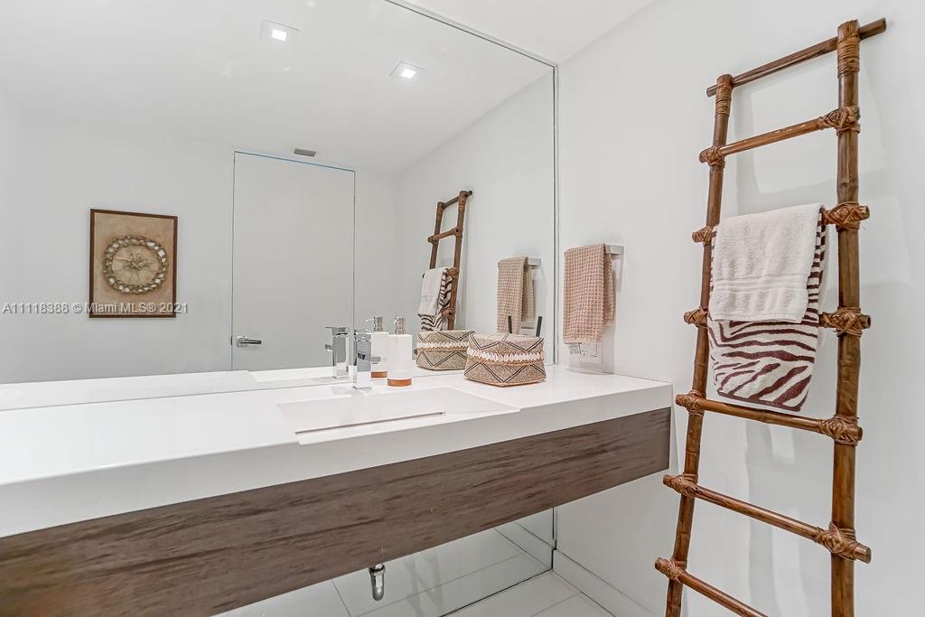 2127 Brickell Avenue, Unit 503 Miami, FL 33129 - Photo 4 of 54 a bathroom with double vanity sink and a mirror