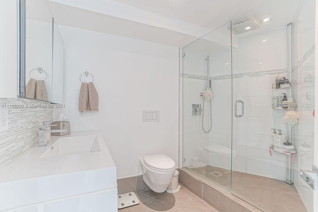 2127 Brickell Avenue, Unit 503 Miami, FL 33129 - Photo 36 of 54 a bathroom with a shower a toilet and a sink