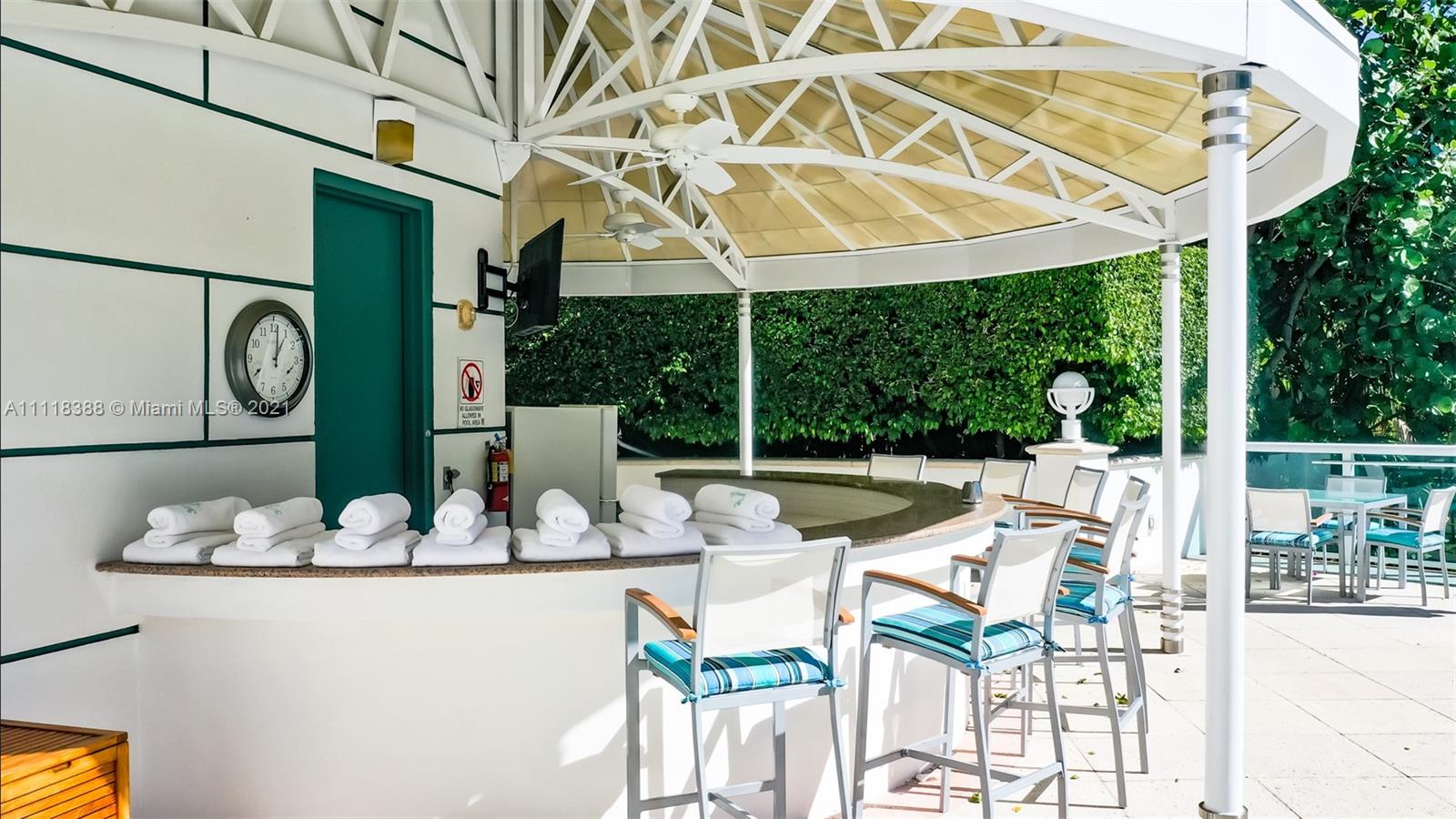 2127 Brickell Avenue, Unit 503 Miami, FL 33129 - Photo 48 of 54 a view of a patio with table and chairs potted plants and large tree