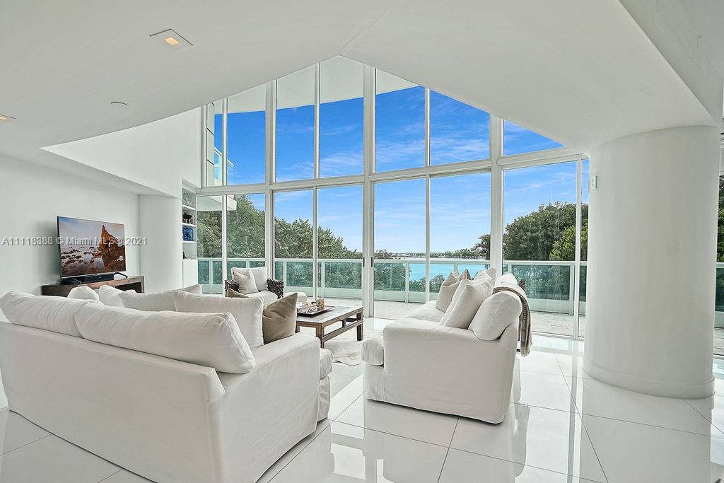 2127 Brickell Avenue, Unit 503 Miami, FL 33129 - Photo 6 of 54 a living room with furniture tv and a large window