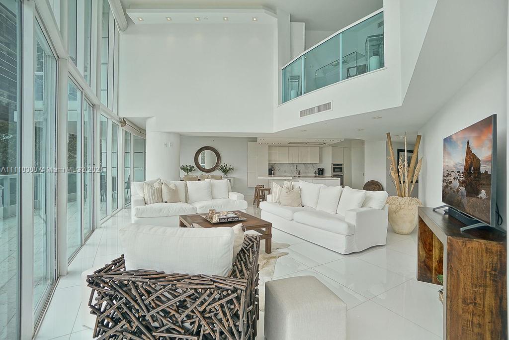 2127 Brickell Avenue, Unit 503 Miami, FL 33129 - Photo 7 of 54 a living room with furniture a flat screen tv and a window