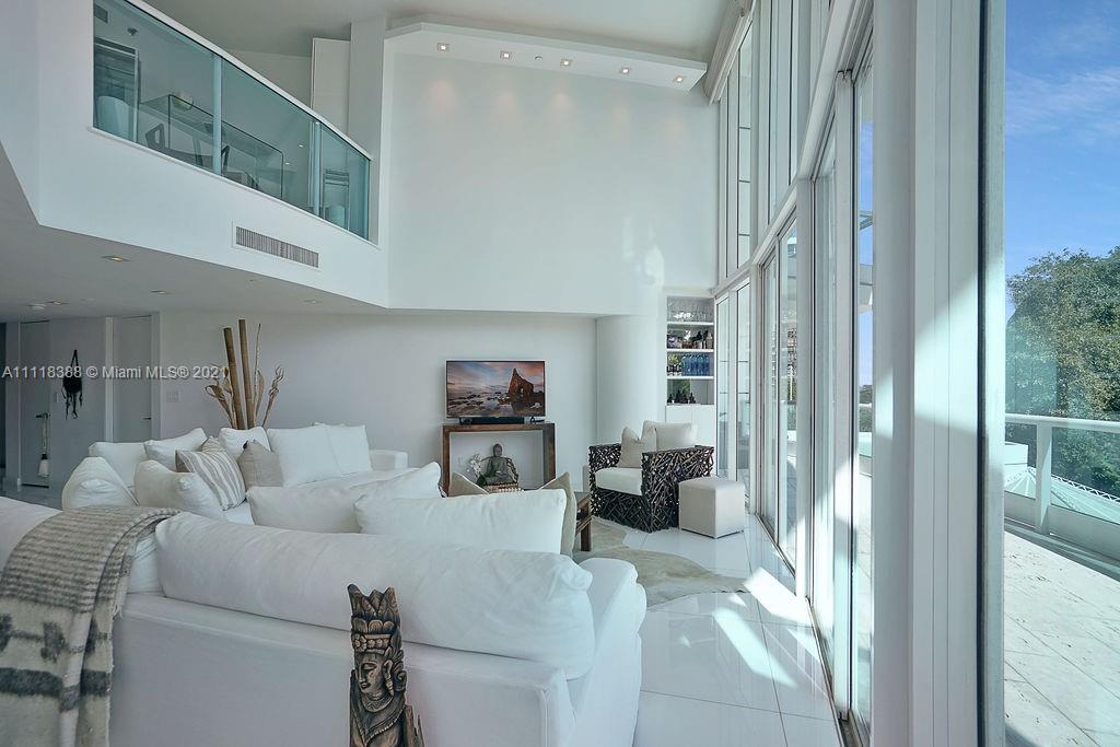 2127 Brickell Avenue, Unit 503 Miami, FL 33129 - Photo 9 of 54 a living room with furniture and a floor to ceiling window