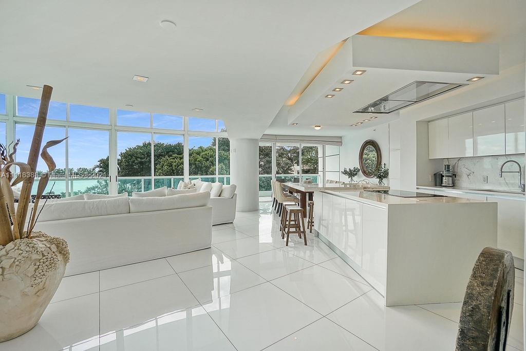 2127 Brickell Avenue, Unit 503 Miami, FL 33129 - Photo 10 of 54 a kitchen with cabinets and chairs