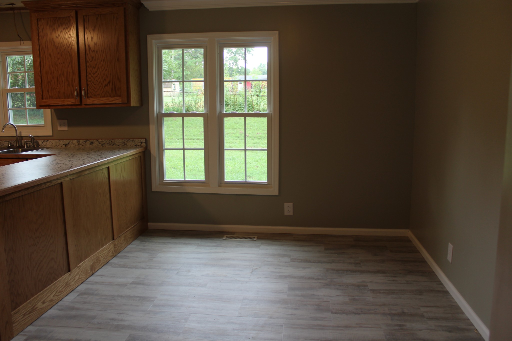 70 Pond Drive Tennessee Ridge, TN 37178 - Photo 6 of 28 a view of an empty room with wooden floor and a window