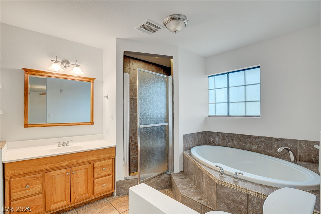 1810 Pinto Road Henderson, NV 89002 - Photo 38 of 53 Indulge in a tranquil bathing experience with a generous tub and a functional walk-in shower.