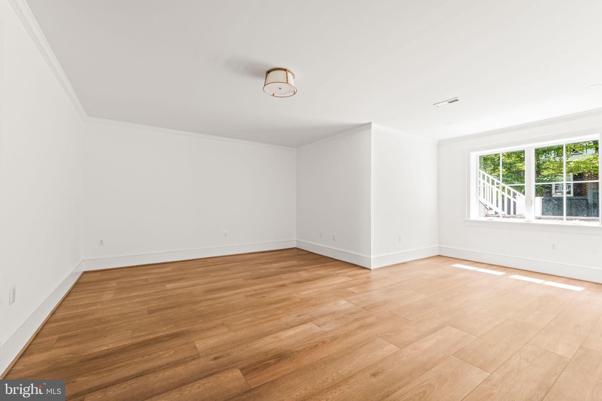 414 Rucker Place Alexandria, VA 22301 - Photo 101 of 135 an empty room with wooden floor and windows