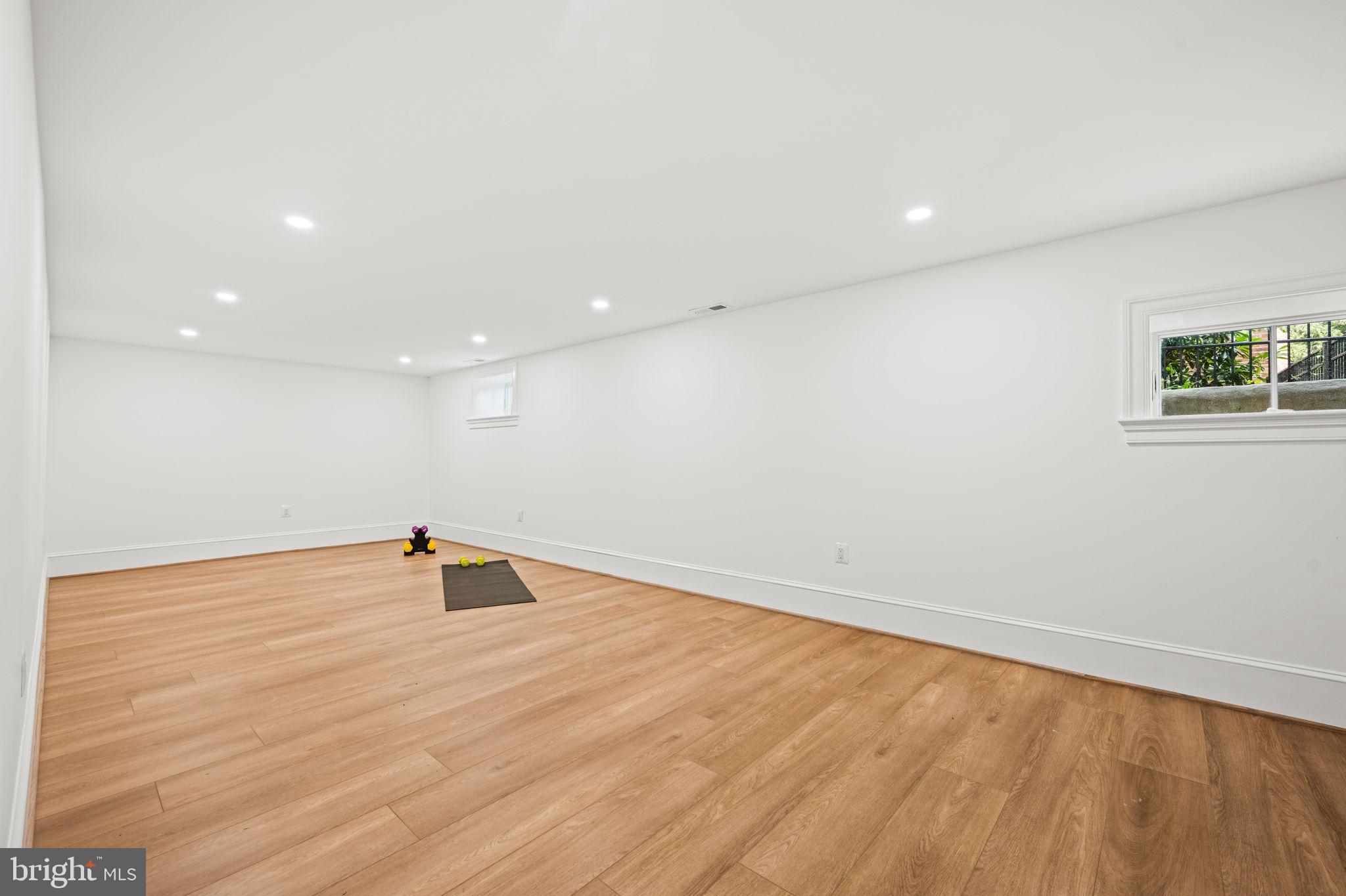 414 Rucker Place Alexandria, VA 22301 - Photo 106 of 135 a view of an empty room with wooden floor and a window