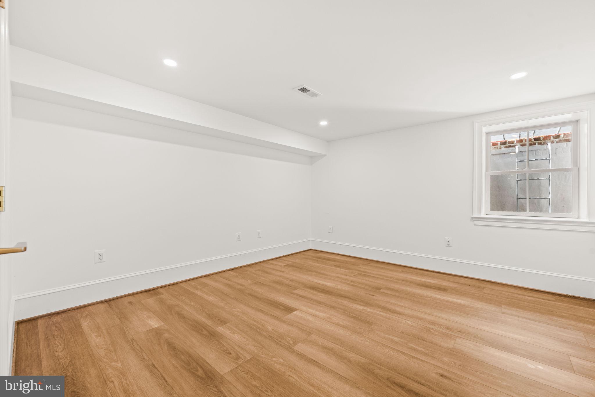 414 Rucker Place Alexandria, VA 22301 - Photo 109 of 135 wooden floor in an empty room with a window