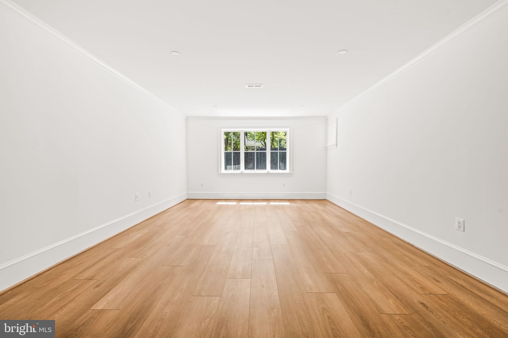 414 Rucker Place Alexandria, VA 22301 - Photo 110 of 135 an empty room with wooden floor and windows
