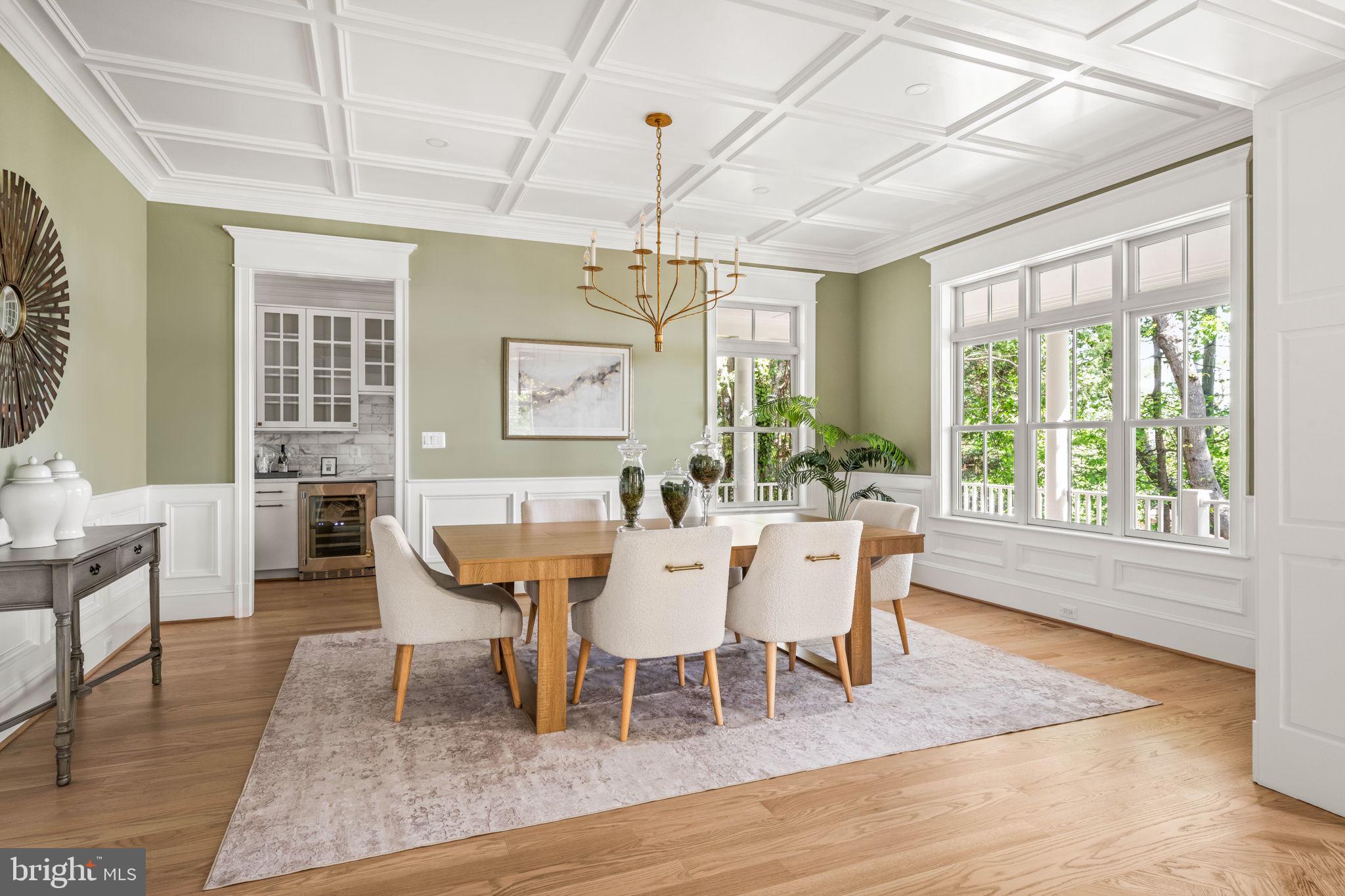 414 Rucker Place Alexandria, VA 22301 - Photo 16 of 135 a dining room with wooden floor a chandelier a wooden table and chairs