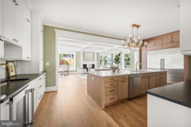 a living room with furniture large window and a fireplace