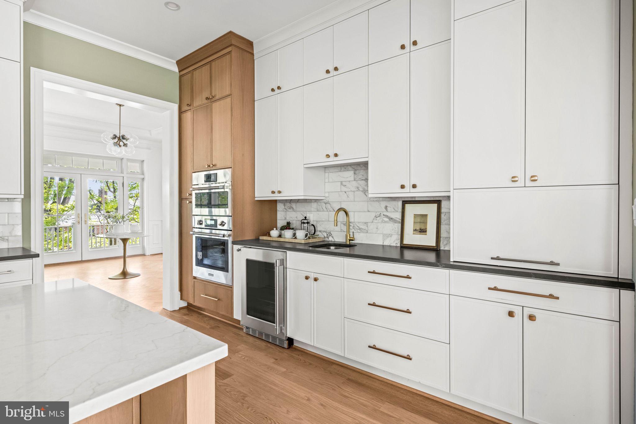 414 Rucker Place Alexandria, VA 22301 - Photo 37 of 135 a kitchen with granite countertop white cabinets and white appliances