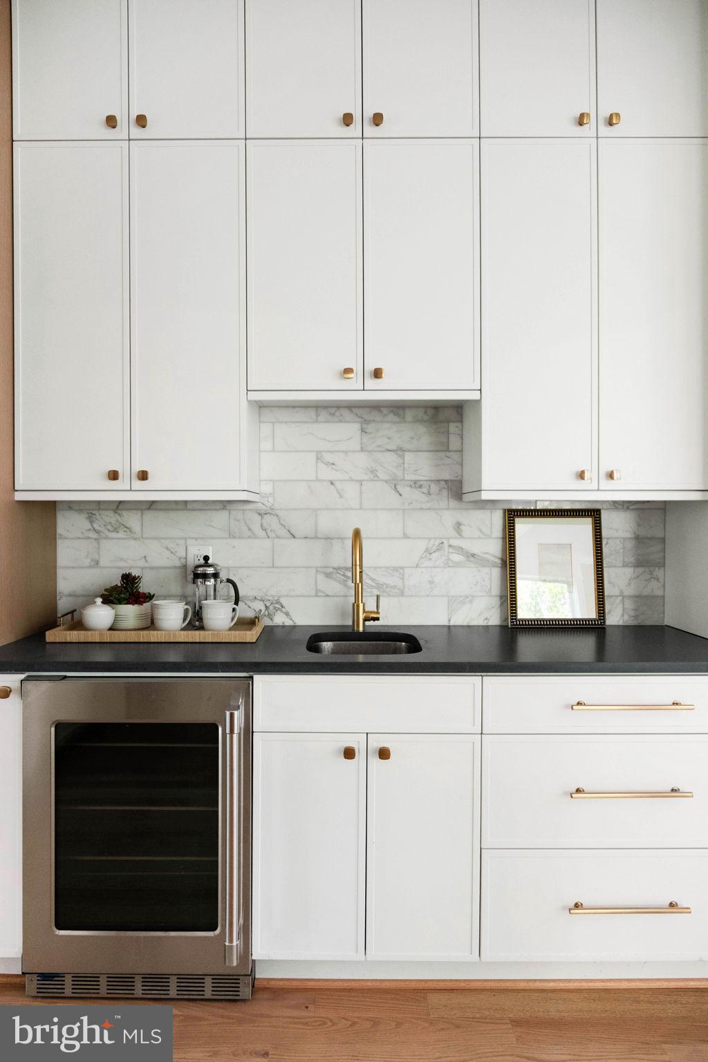 414 Rucker Place Alexandria, VA 22301 - Photo 39 of 135 a kitchen with granite countertop white cabinets and stainless steel appliances