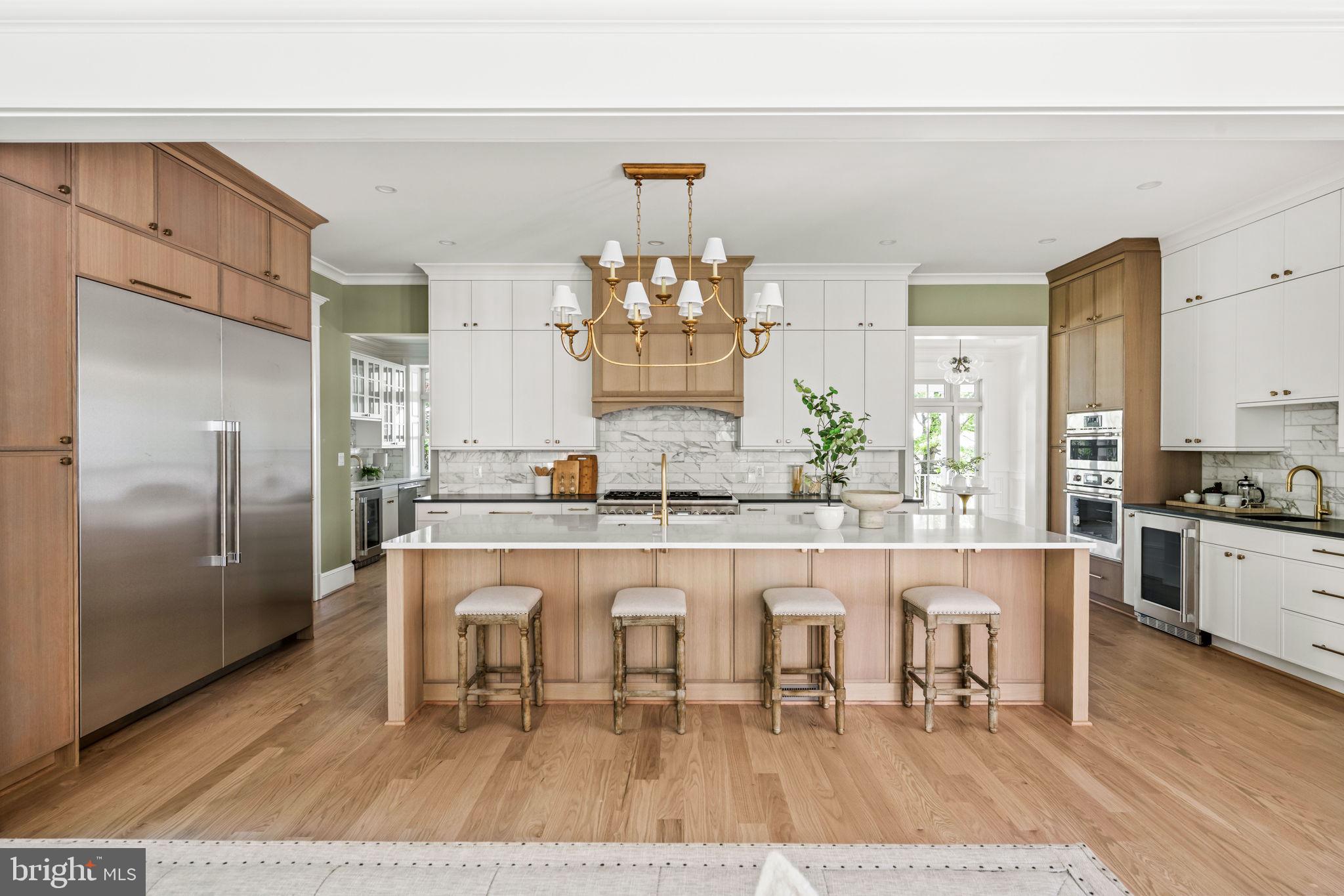 414 Rucker Place Alexandria, VA 22301 - Photo 43 of 135 a large white kitchen with granite countertop a stove a refrigerator and a dining table