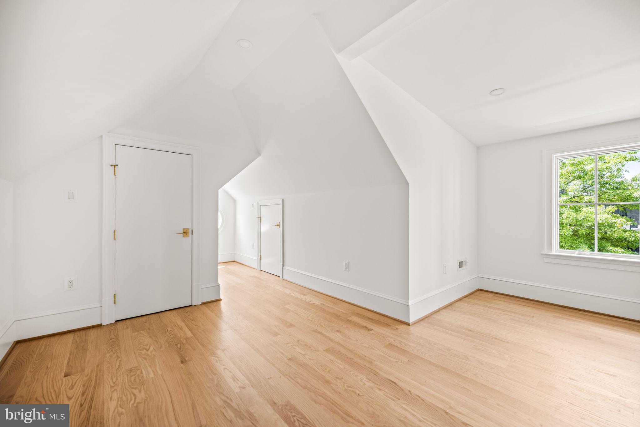 414 Rucker Place Alexandria, VA 22301 - Photo 90 of 135 a view of an empty room with wooden floor and a window