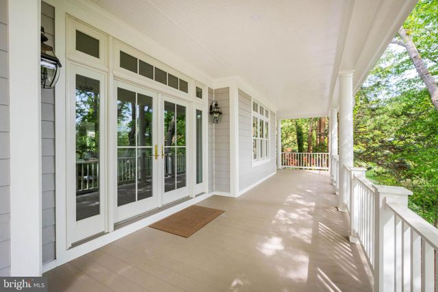 a living room with fireplace furniture and a large window