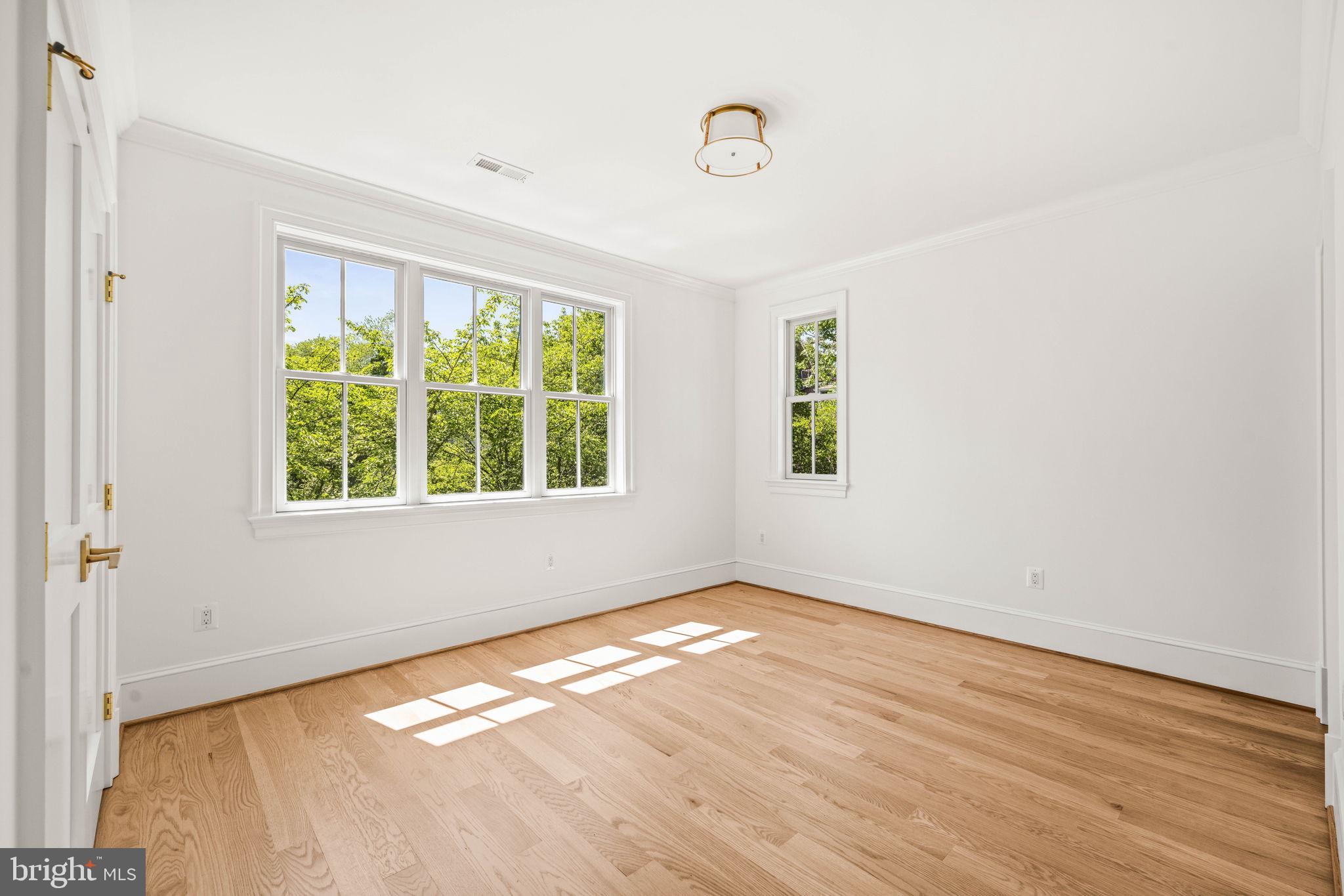 414 Rucker Place Alexandria, VA 22301 - Photo 99 of 135 an empty room with wooden floor and windows
