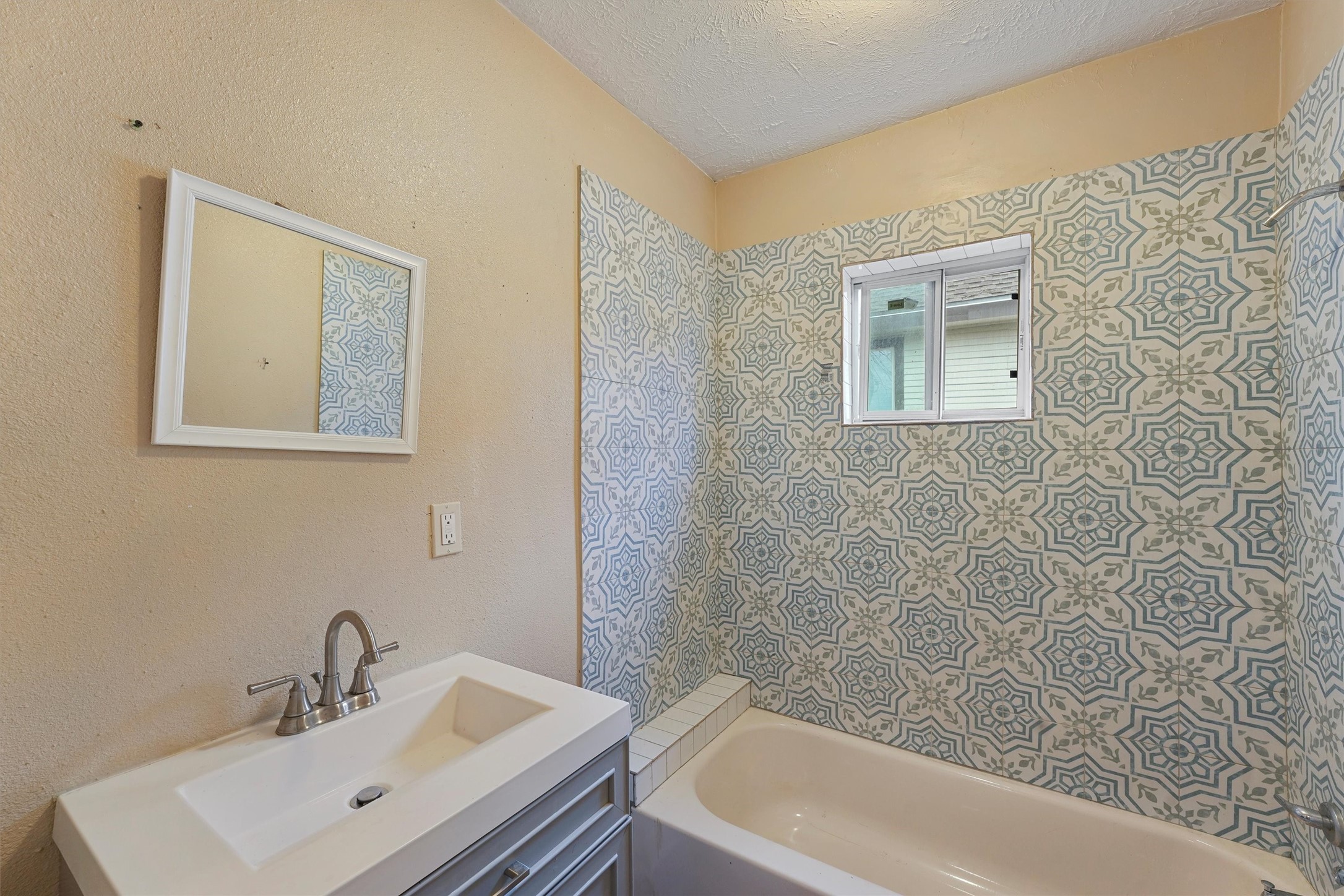 3706 Delano Street Houston, TX 77004 - Photo 6 of 21 a bathroom with a bathtub sink and mirror