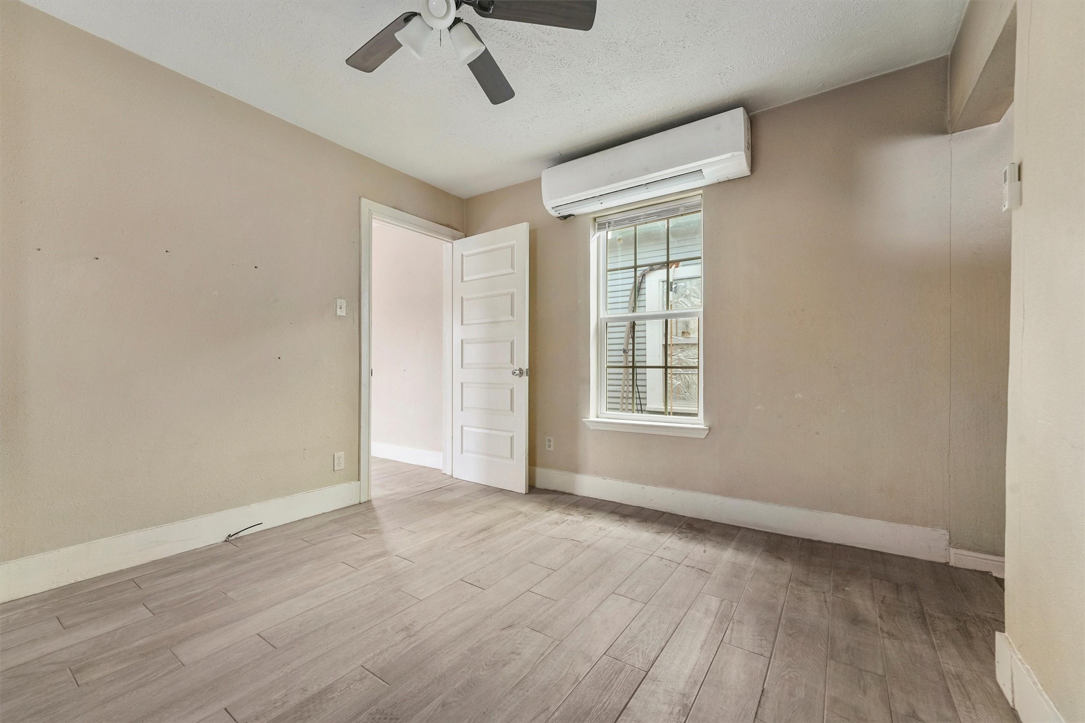 3706 Delano Street Houston, TX 77004 - Photo 10 of 21 a view of an empty room with a window and wooden floor