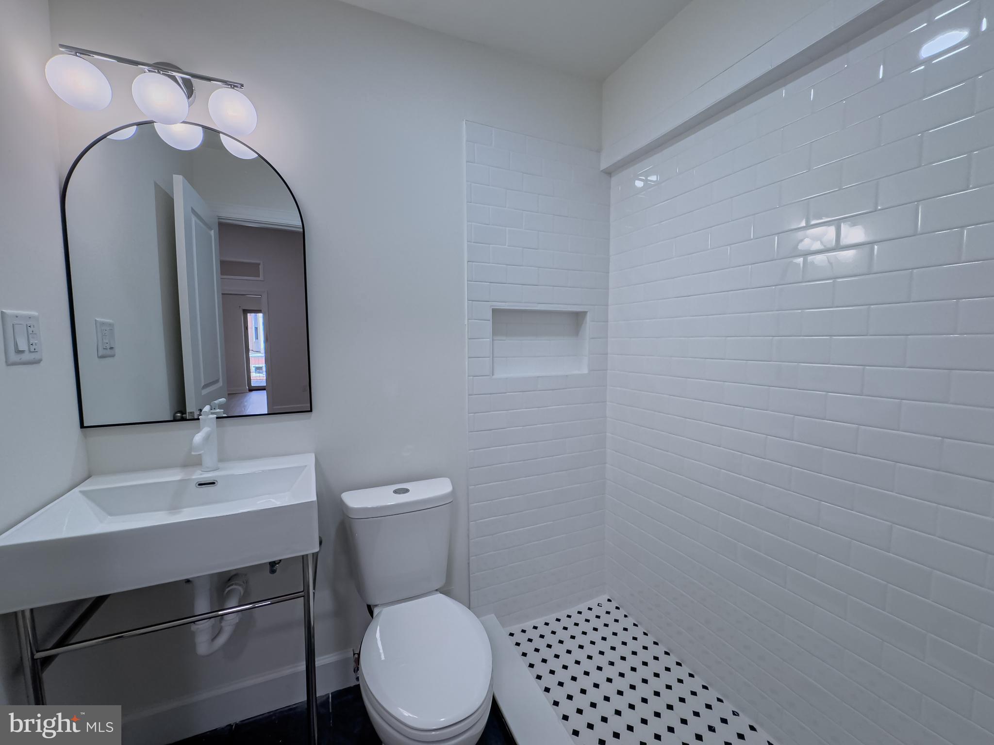 2007 Green Street, Unit 2R Philadelphia, PA 19130 - Photo 8 of 15 a bathroom with a toilet a sink and mirror